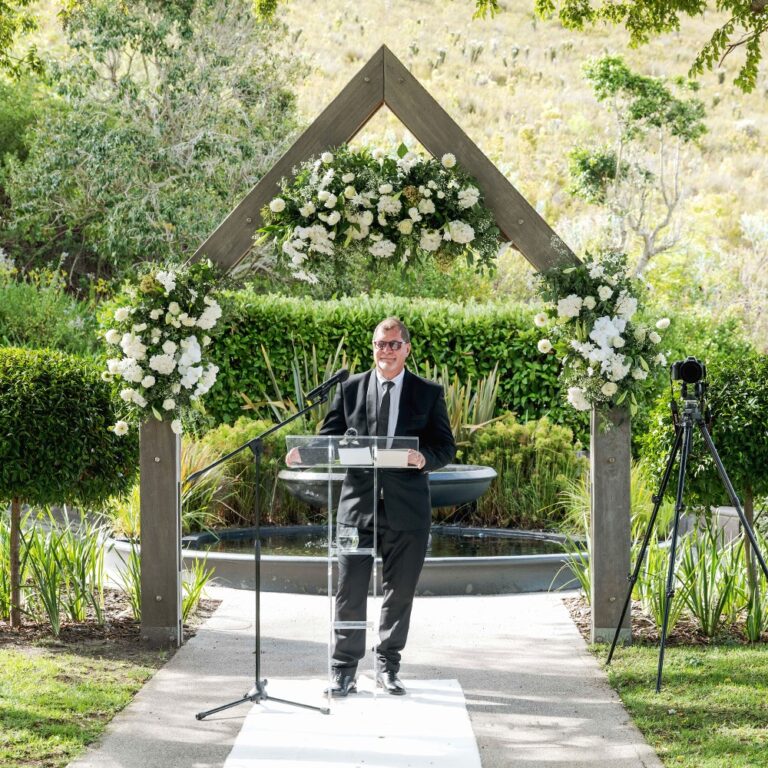 Ceremony at the timber arch beside the water feature, Bona Dea Private Estate