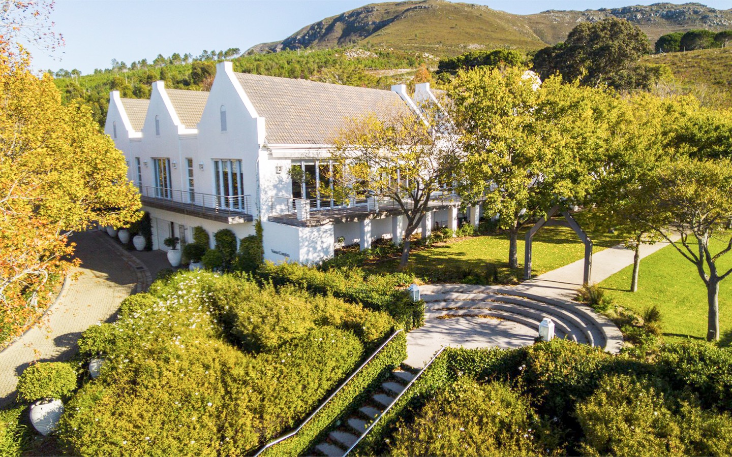 Aerial view of the manor house, gardens and amphitheatre steps, Bona Dea Private Estate