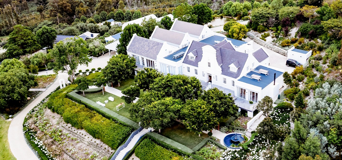 Aerial view of the estate buildings and terraced gardens, Bona Dea Private Estate