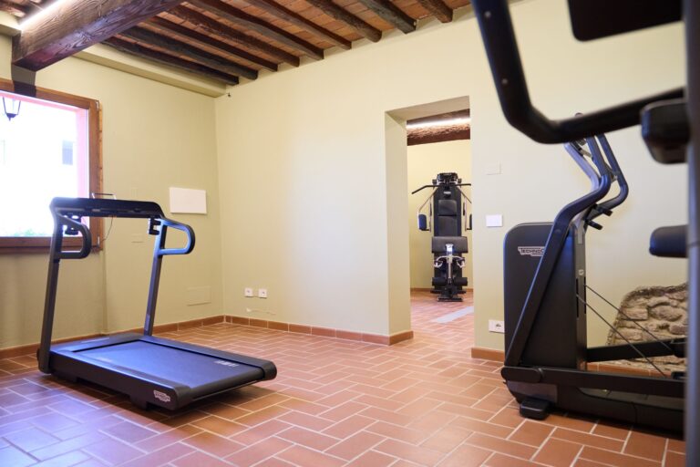 The gym, with treadmill and cross trainer, Borgo Bucciano