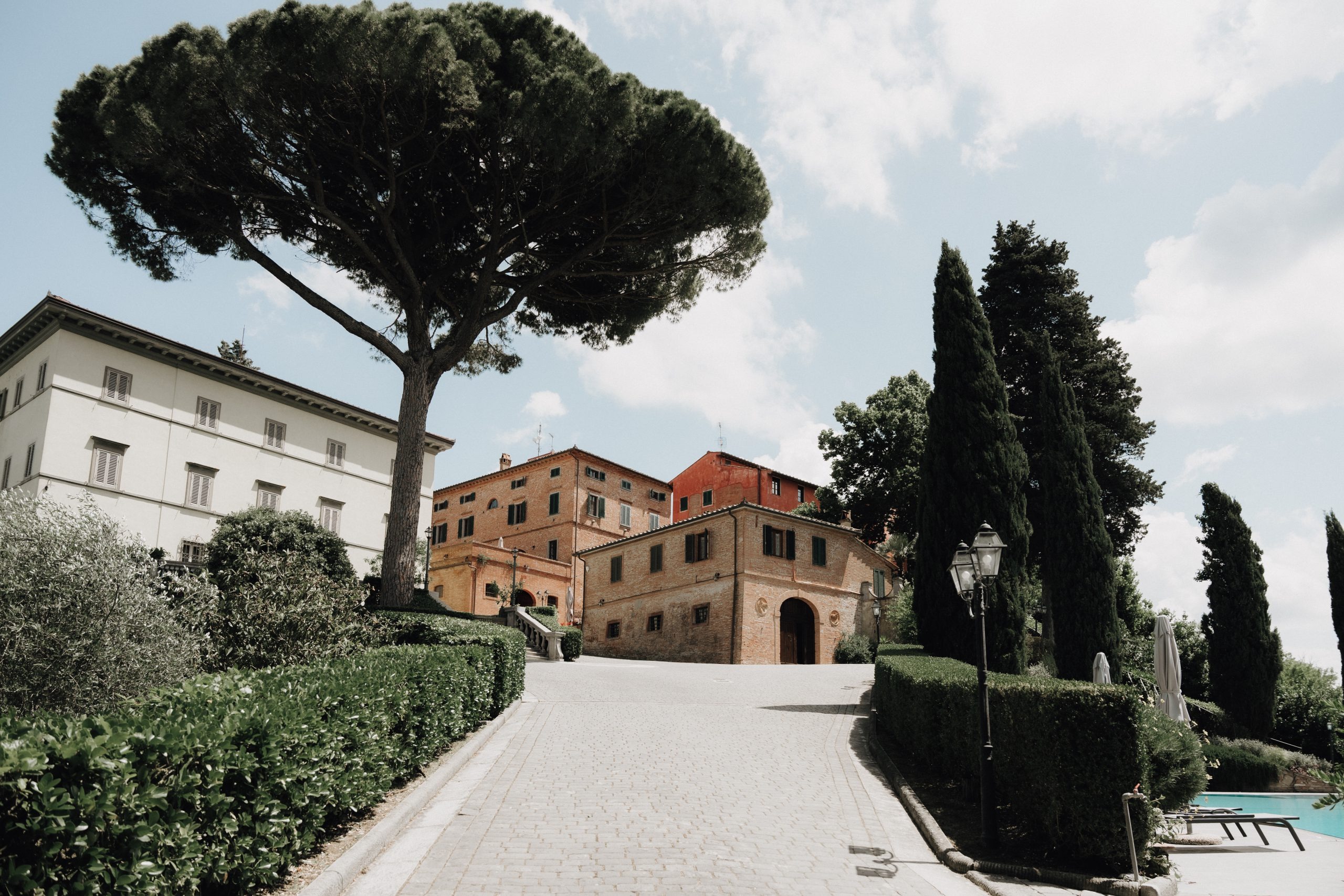 The Fattoria and the villa seen from the drive under the umbrella pines, Borgo Bucciano