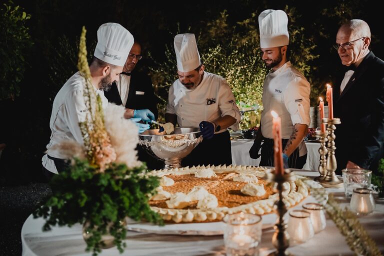 Chefs finishing a dessert at the table, Borgo Bucciano