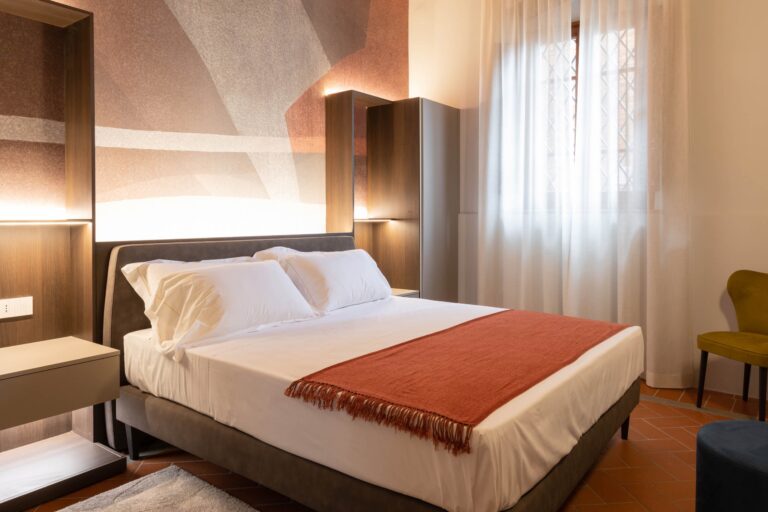 A bedroom with a terracotta ceiling and double bed, Borgo Bucciano