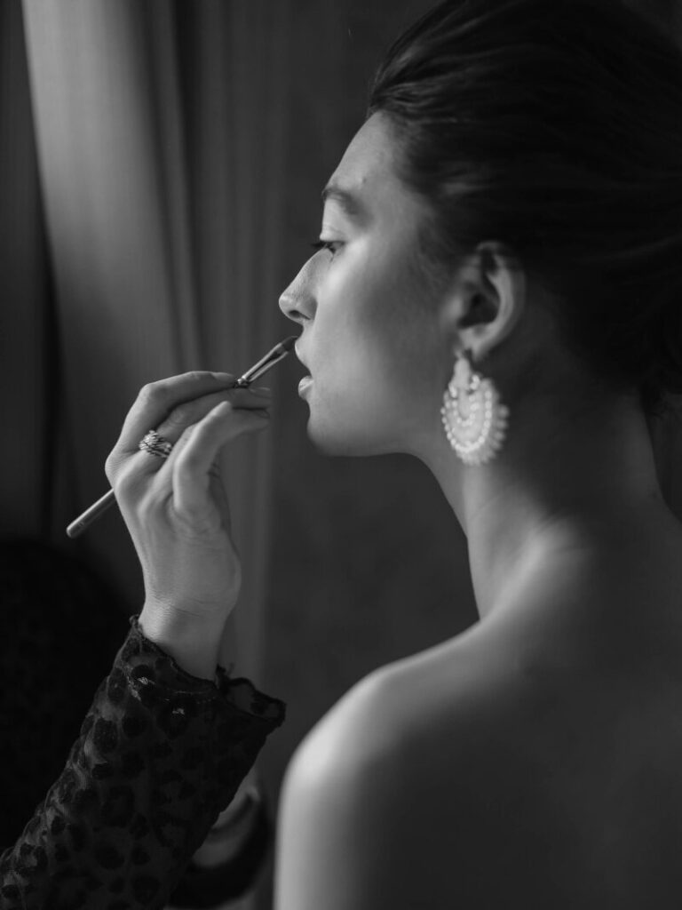 A precise hand at work on the final line of lip colour, Botias