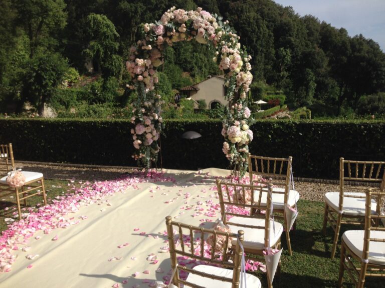 Floral arch and petal-strewn aisle at a hillside ceremony, Bottega dei Fiori by Ezio De Angelis