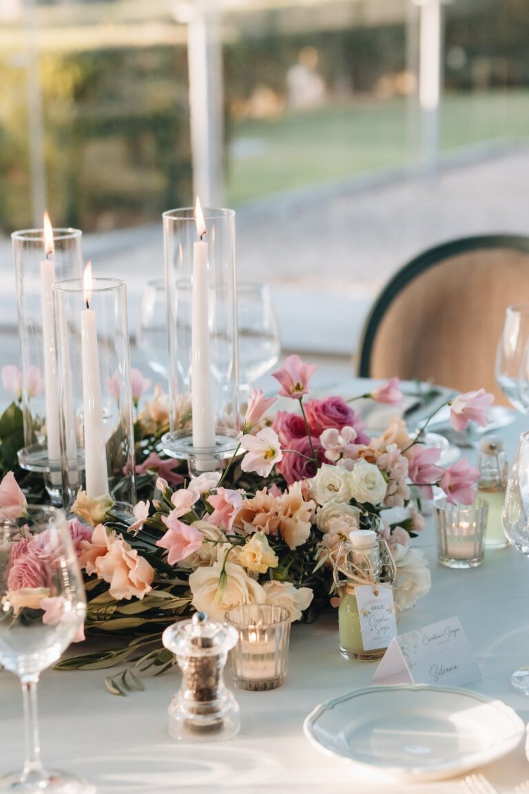 Table set with candles and pink and cream flowers, Bottega dei Fiori by Ezio De Angelis