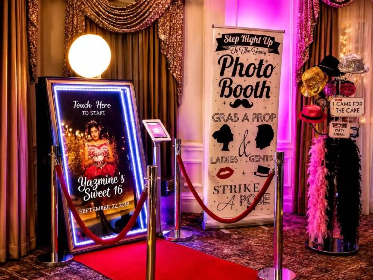 A mirror booth with a custom touch screen, feather boas and a prop sign, Box Entertainment