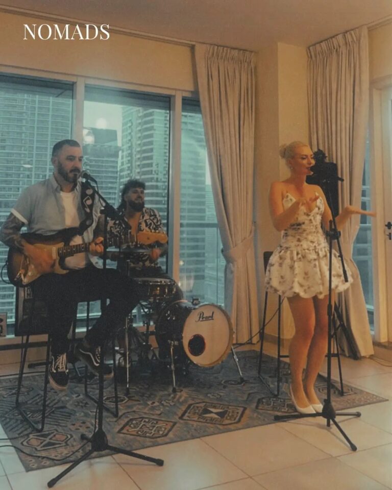 A live trio performing in a high-rise apartment with a skyline view, Box Entertainment