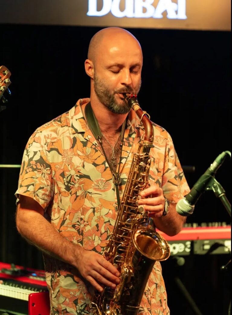 A saxophonist playing live at an evening event, Box Entertainment