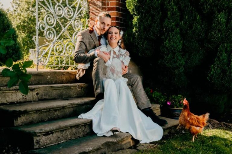 The couple on weathered stone garden steps framed by ivy, Briery Hill House
