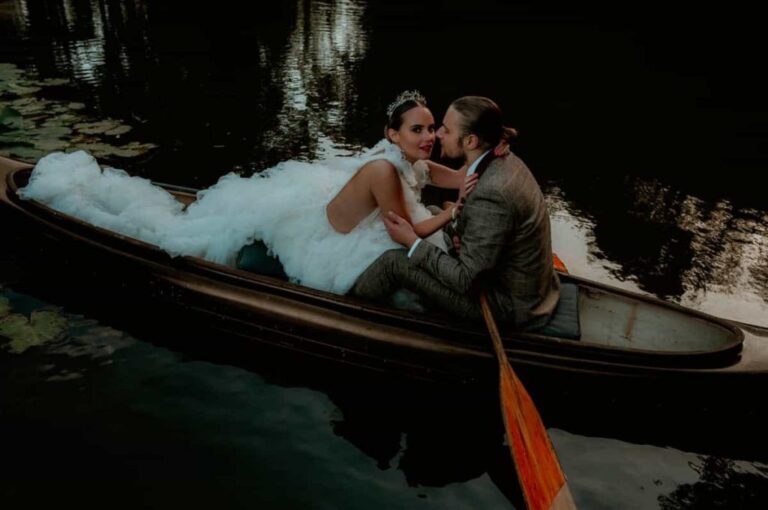 The couple in a wooden rowing boat on the estate lake at dusk, Briery Hill House