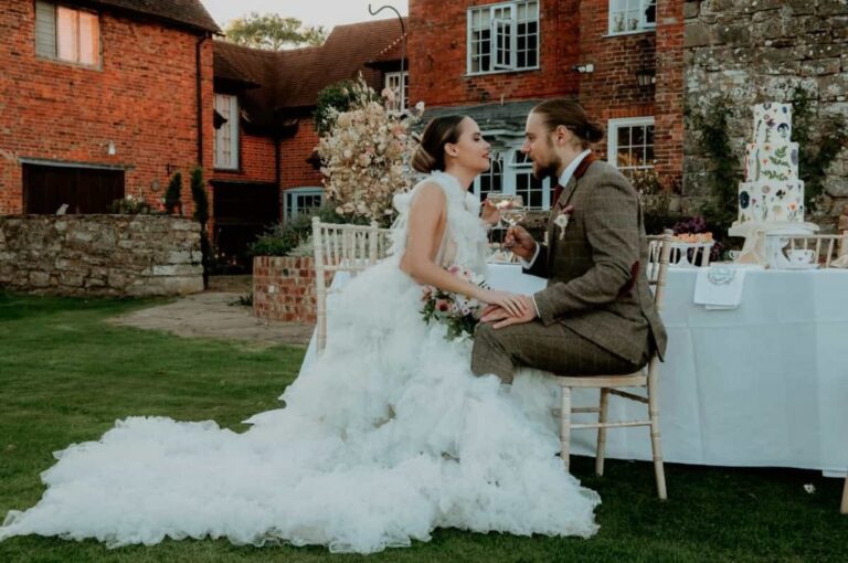A styled outdoor dining table, the red-brick estate building behind, Briery Hill House