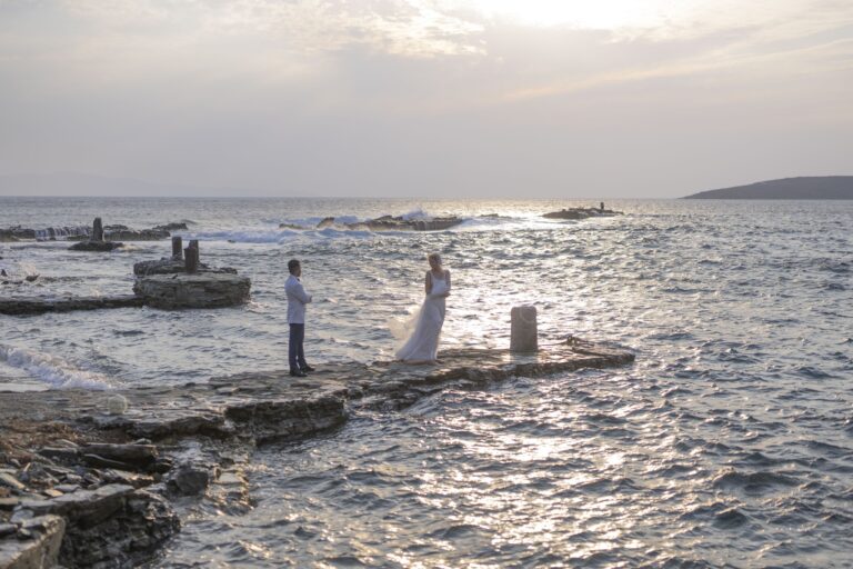 Couple on the rocks by the sea at dusk, Bright Blue Wedding And Events