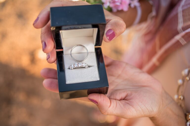 Rings in an open box held by the couple, Paros, Bright Blue Wedding And Events