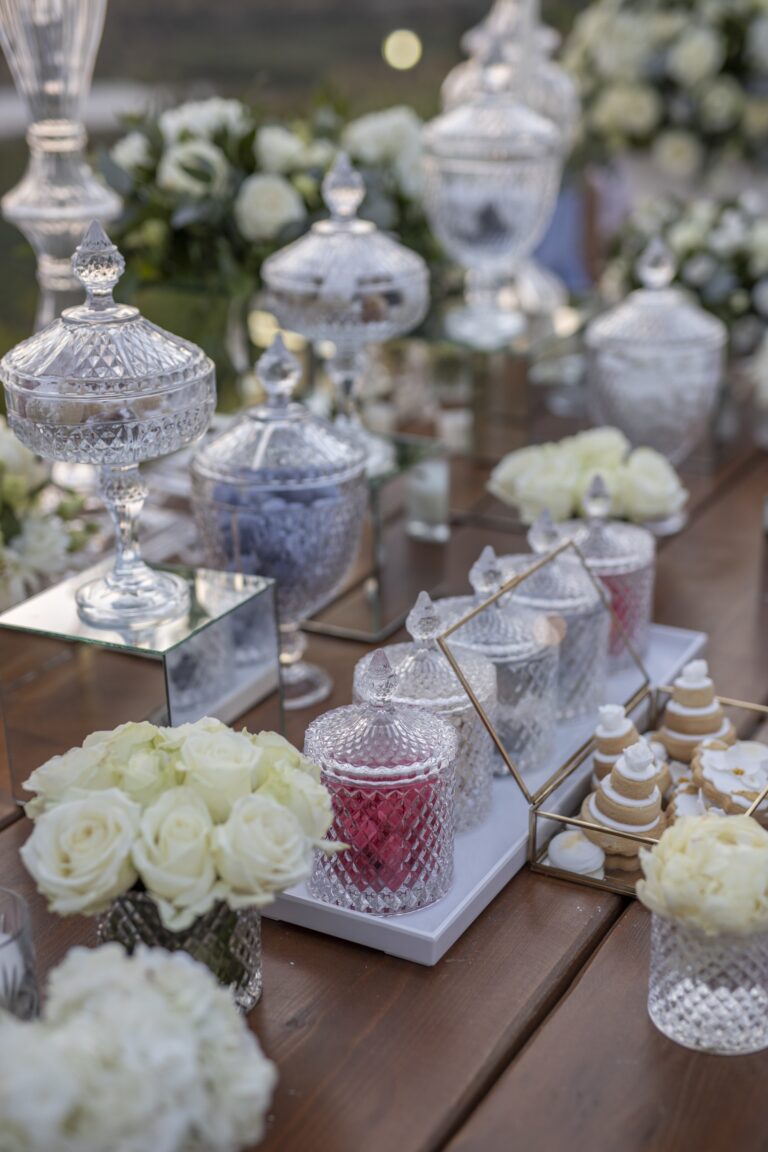 Dessert table with glass apothecary jars and white roses, Bright Blue Wedding And Events