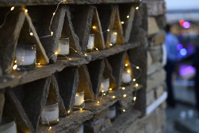 Candles set in rustic wooden niches with fairy lights, Bright Blue Wedding And Events