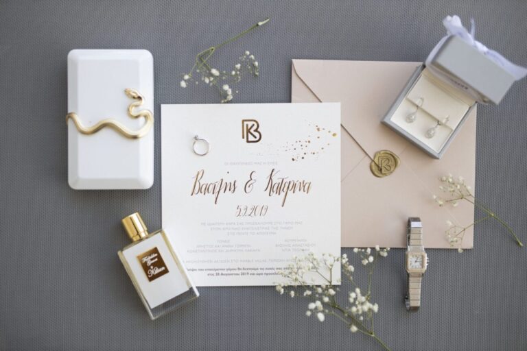 Invitation suite flat lay with rings and perfume, Bright Blue Wedding And Events