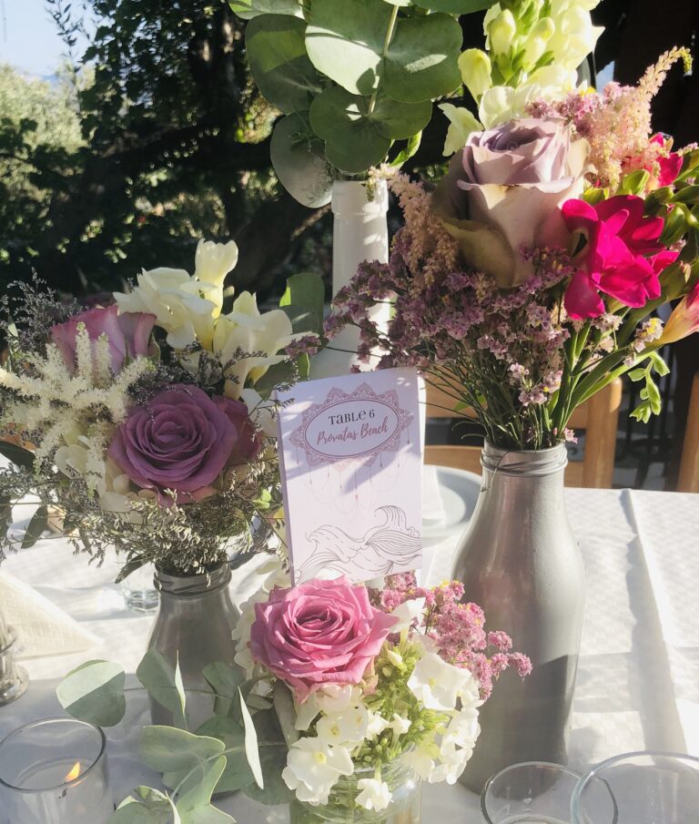 Table flowers and a place card in a pewter vase, Milos, Bright Blue Wedding And Events