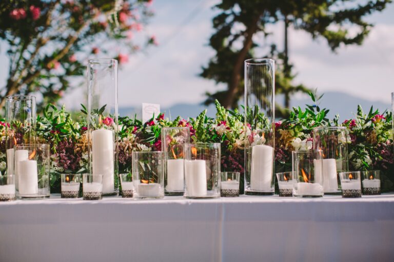 Long table with candles and flowers in glass holders, Milos, Bright Blue Wedding And Events