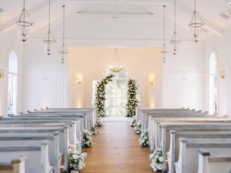 White chapel interior with flowers framing the aisle, Palmetto Bluff, South Carolina, Brilliant Event Planning