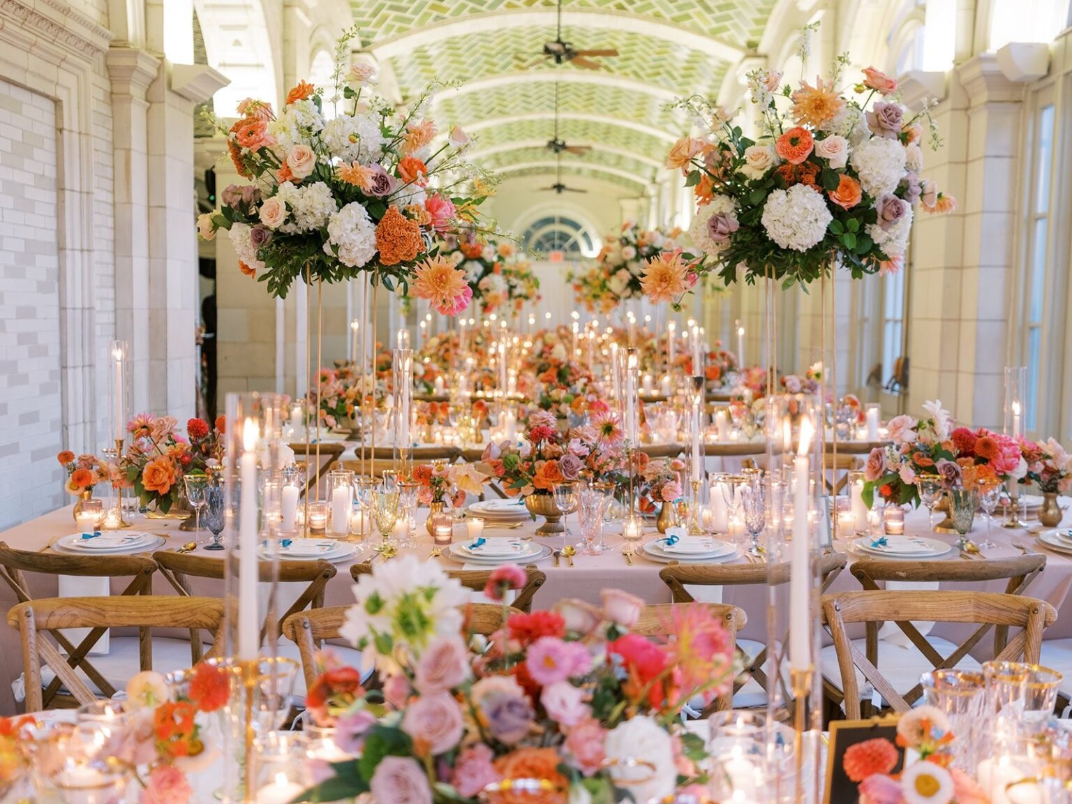 Candlelit tables beneath hanging florals in a Brooklyn boathouse