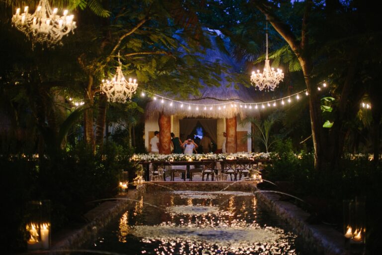 Chandeliers and string lights over a reception set at the water, Riviera Maya, Brilliant Event Planning