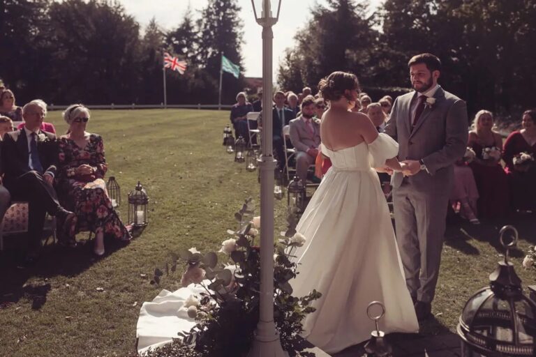 An outdoor ceremony under way, guests seated on the lawn, the fells beyond, Broadoaks Country House