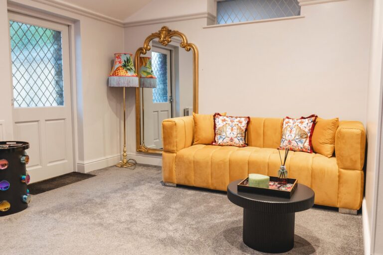 The Wedding Prep Room lounge, mustard velvet sofa, gilt mirror and leaded window, Broadoaks Country House