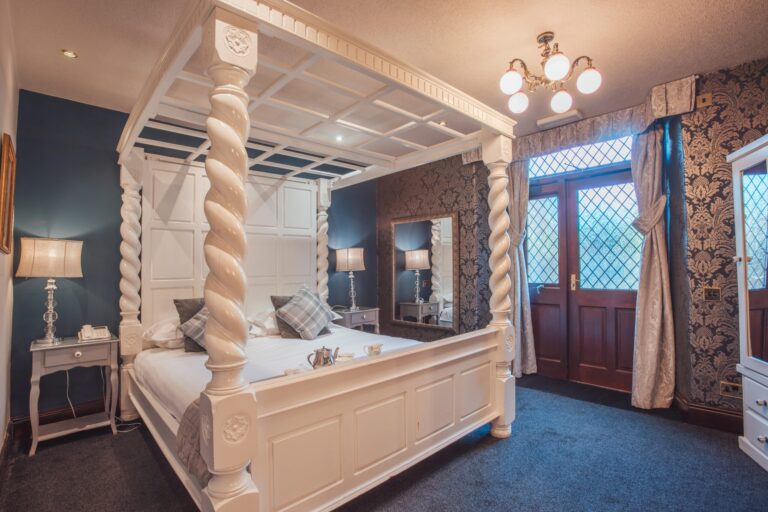 Walnut, the accessible bedroom, with a white super-king four-poster, Broadoaks Country House
