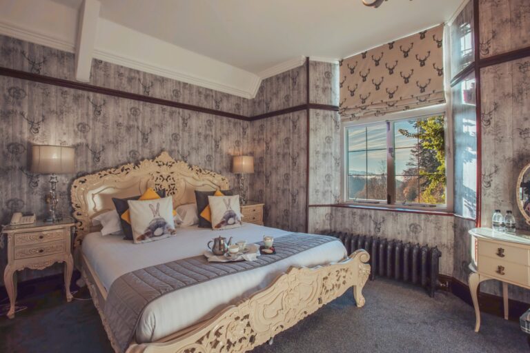 Ash, a carved French bed against patterned walls, Broadoaks Country House