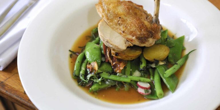 A plated main course, roast poultry with greens and jus, Broadoaks Country House