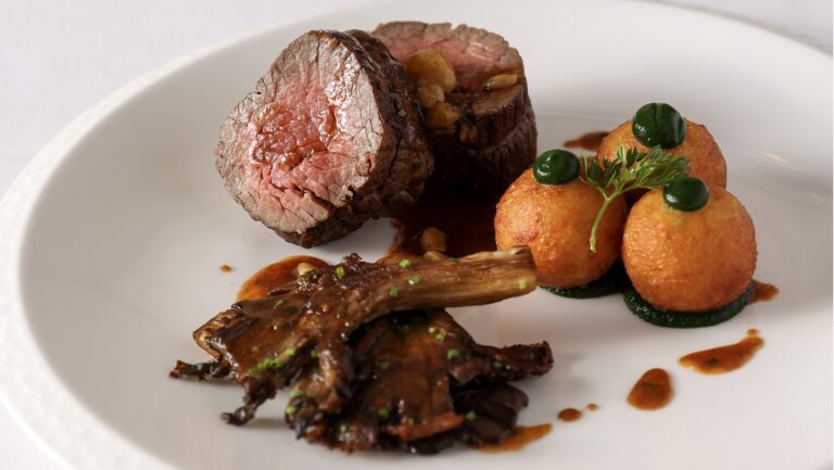 A main course of pink beef with a braised cut, croquettes and a dark jus, from the Auberge du Lac kitchen, Brocket Hall