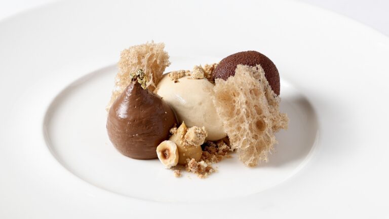 A chocolate and hazelnut dessert with ice cream and lace tuiles on a white plate, Brocket Hall