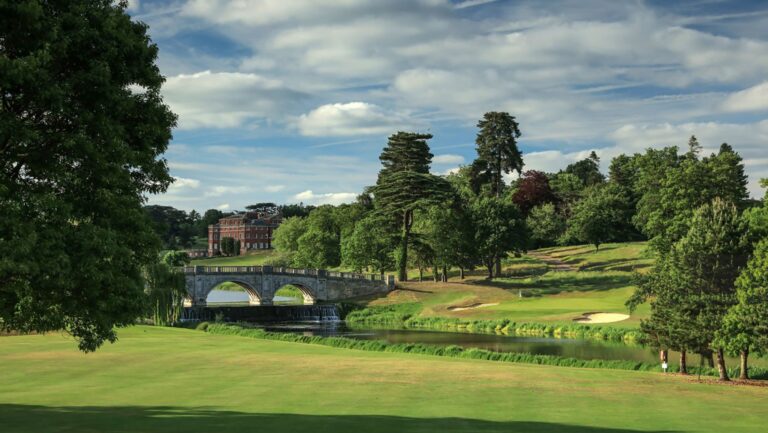 The Paine Bridge and the Hall beyond it, seen across the parkland and a green of the Melbourne course, Brocket Hall