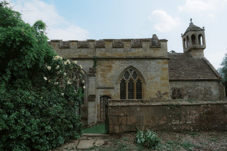 St Andrew's Church beside the house, with its castellated wall and small bell turret, Brympton House