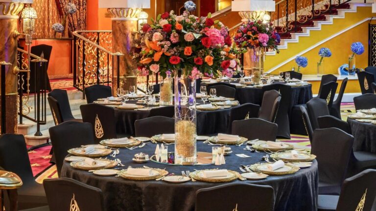 Banquet tables with floral centrepieces and gold-rimmed plates, Burj Al Arab Jumeirah