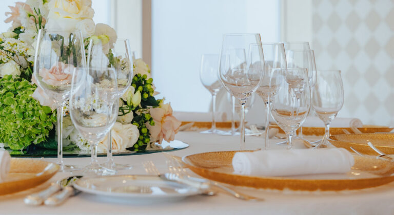 Table laid with a floral centrepiece and gold-rimmed plates, Burj Al Arab Jumeirah