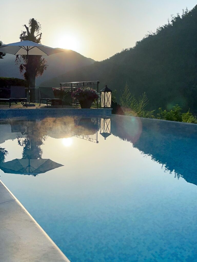 The pool at dusk, the hills reflected in the water, Burlamacchi Villas