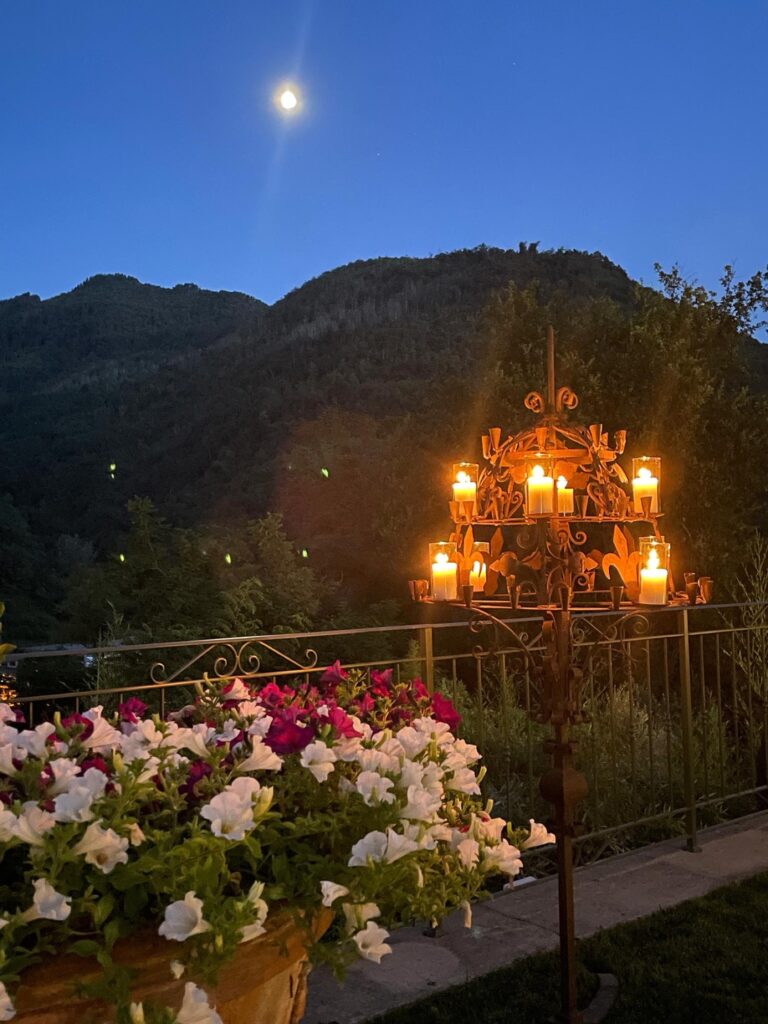 Candelabra and flowers on the terrace at dusk, Burlamacchi Villas