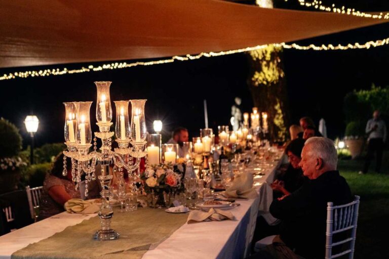 A candlelit wedding dinner in the garden at night, Burlamacchi Villas