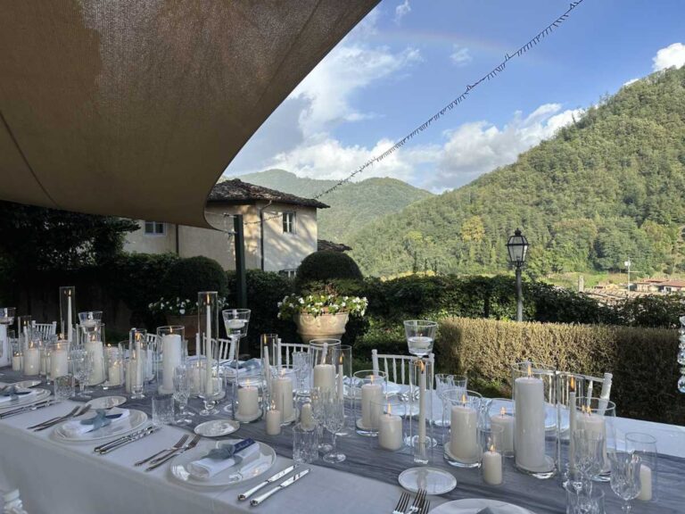 A long table under the canopies, the hills beyond, Burlamacchi Villas