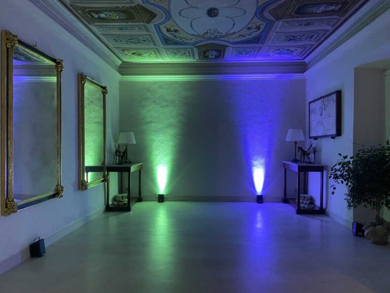 A frescoed salon lit for the evening, Burlamacchi Villas