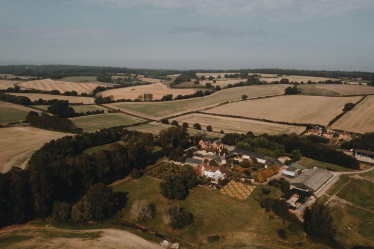 The farm buildings in their setting of fields and woodland on the Surrey and Hampshire border, Bury Court