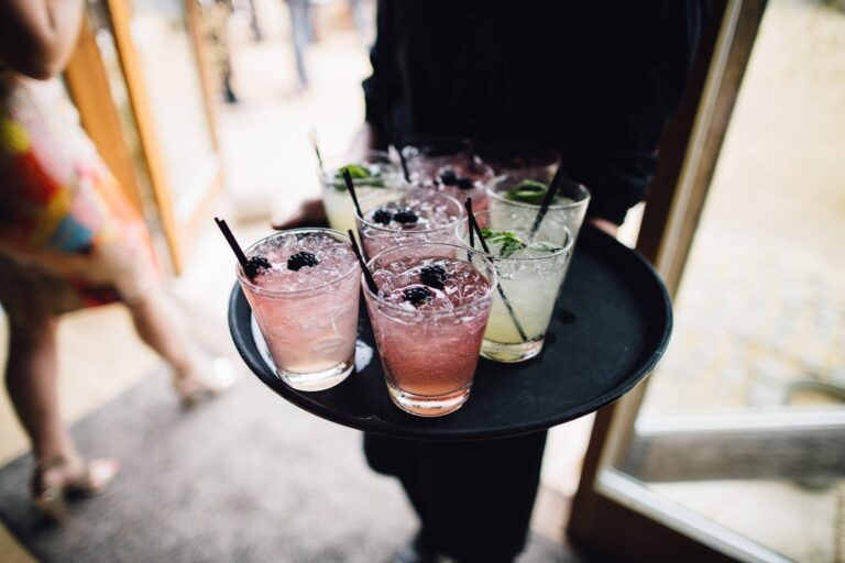 A tray of pink and green cocktails carried out to guests, Bury Court