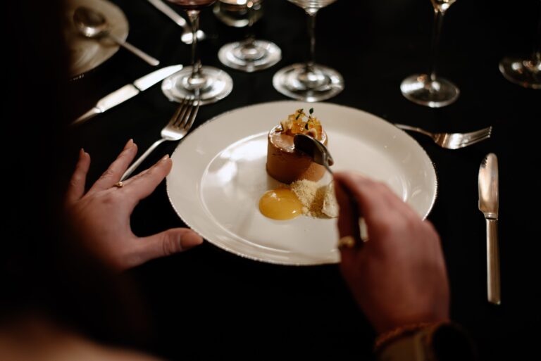 A plated dessert set down at a dinner table with crystal glasses, Bury Court
