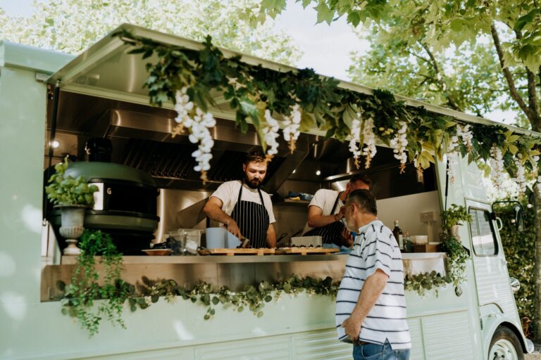 A vintage street food van dressed with wisteria, cooking in the garden, Bury Court