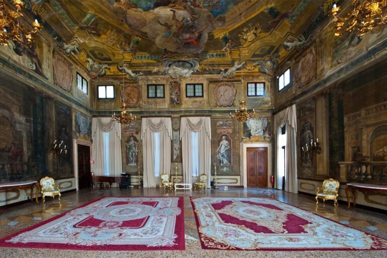 The Sala della Musica, the Music Ballroom, its red carpet and frescoed walls set for a grand reception, Ca' Sagredo Hotel