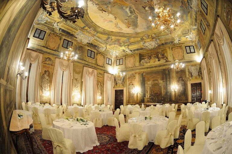 The ballroom laid with round banquet tables beneath the gilded and painted ceiling, Ca' Sagredo Hotel