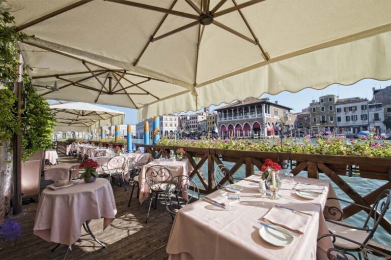 L'Alcova terrace, tables laid under a canopy at the water's edge on the Grand Canal, Ca' Sagredo Hotel