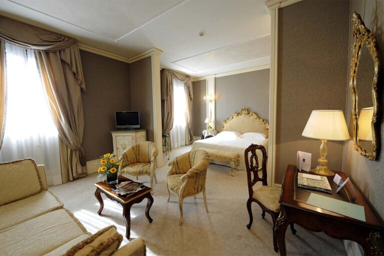 A Deluxe Suite on the Grand Canal, tall windows and a sitting area, Ca' Sagredo Hotel